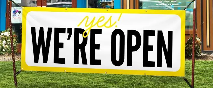 Custom printed vinyl banner outside a storefront